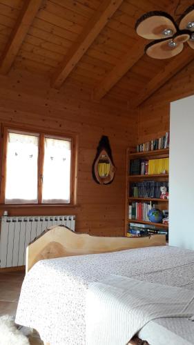 a bedroom with a bed in a wooden room at Chalet Il Fungo in Averara
