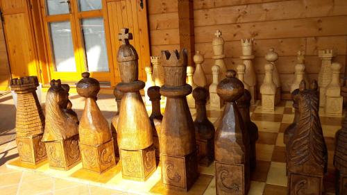 a group of wooden chess pieces sitting on a table at Chalet Il Fungo in Averara