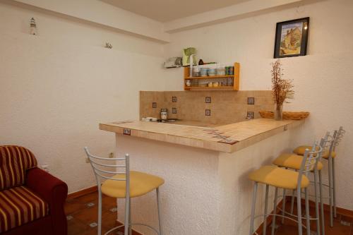 a kitchen with a counter and stools in a room at Apartment Matija in Premantura