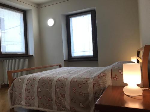 a bedroom with a bed and a table with a lamp at San Martino in Lazise