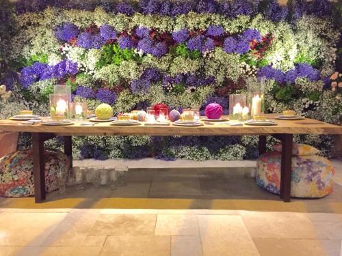 a table with candles and plates of food and flowers at Tenuta del Lauro in Locorotondo