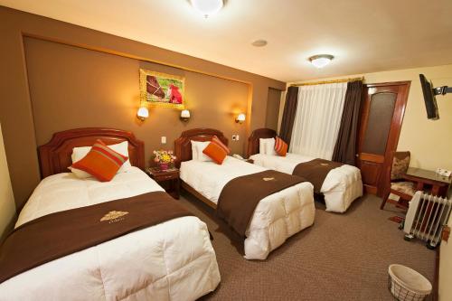 En eller flere senge i et værelse på Hotel Mabey Cusco