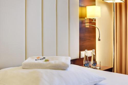 a hotel room with a bed with a towel on it at Amber Hotel in Gdańsk