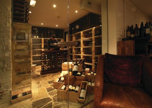 a wine tasting room with a man in a wine cellar at Hotel du Vin & Bistro Cambridge in Cambridge