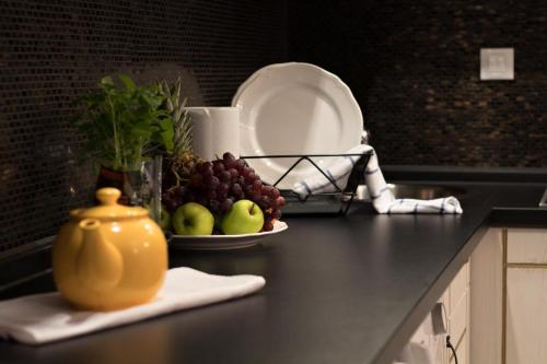 a plate of fruit on a kitchen counter at Residence Vaclavska in Prague