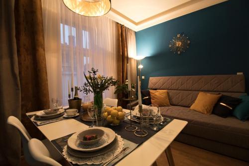 a living room with a table and a couch at Residence Vaclavska in Prague