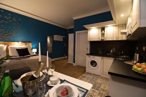 a room with a bed and a kitchen with a table at Residence Vaclavska in Prague