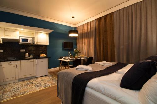 a hotel room with a bed and a kitchen at Residence Vaclavska in Prague