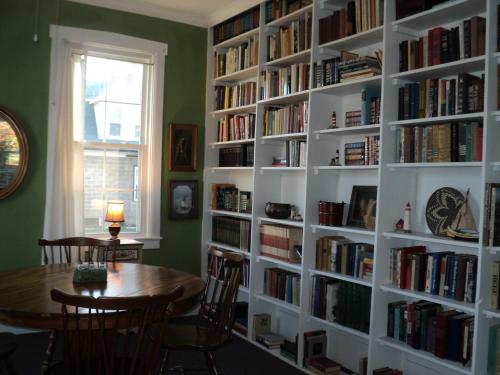 a room with a book shelf filled with books at Harbor Haus Inn & Suites in Hermann