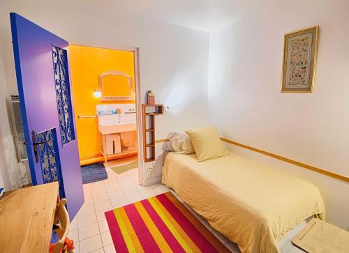 1 dormitorio con 1 cama y 1 habitación colorida en Paris-Oasis "All Inclusive", en París