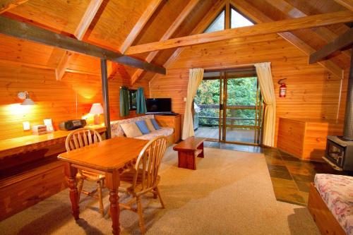 a dining room with a table in a cabin at Mt Glorious Getaways in Mount Glorious
