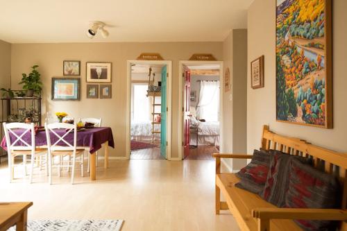 a living room with a table and a dining room at Pueblo Canyon Inn in Los Alamos