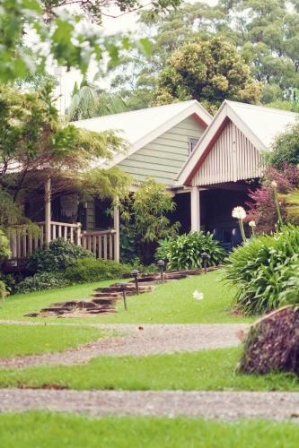 a house with a porch and a yard at Mt Glorious Getaways in Mount Glorious