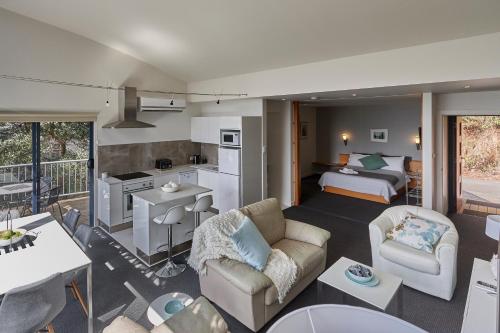 a living room with a kitchen and a bedroom at Tamar River Apartments in Rosevears