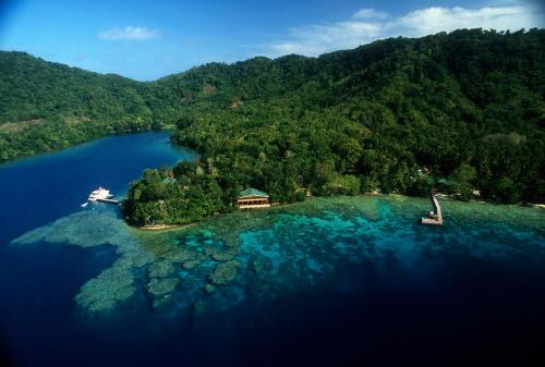 an island in the middle of a body of water at Tawali Leisure & Dive Resort in Alotau