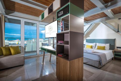 a bedroom with a bed and a desk in a room at Infinity City Boutique Hotel in Heraklio Town