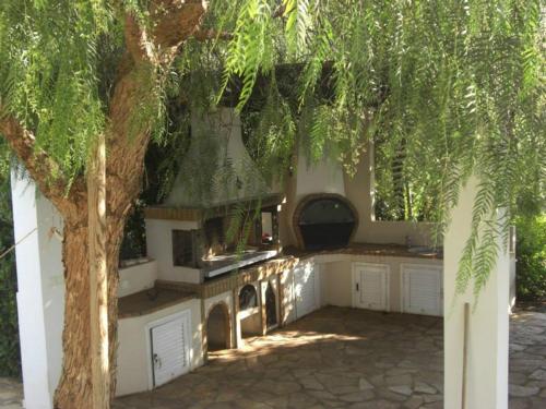 a kitchen with a tree in front of a house at Luxury Villa Flora Kiparissia in Kyparissia