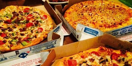 three pizzas in boxes sitting on a table at 1 Orange Hotel KLIA & KLIA2 in Sepang