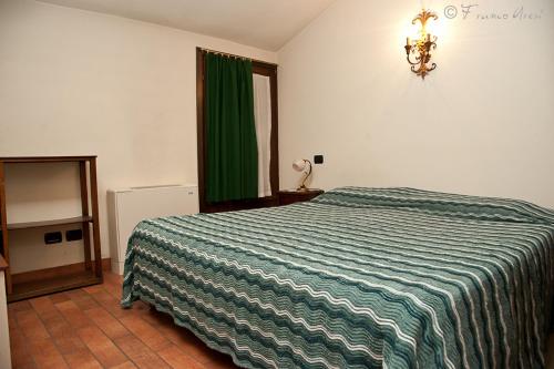 Ένα ή περισσότερα κρεβάτια σε δωμάτιο στο Agriturismo La Garzonera