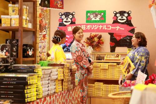 two women standing in front of a counter in a store at Yumeoi-so in Aso
