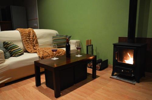 a living room with a couch and a fireplace at Casa Rural La Tramontana in Estivella