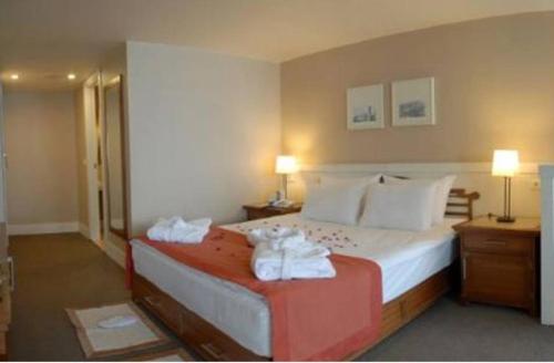 a hotel room with a bed with towels on it at Masal Otel in Kocaeli