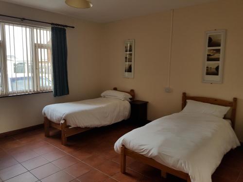 a room with two beds and a window at Ingoldale Park Apartments in Ingoldmells