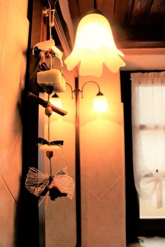 a room with a lamp and a mirror and a light at Ca di Voi in Calizzano
