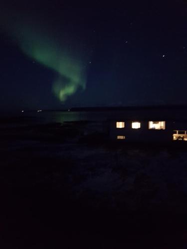 an aurora in the sky at night with a train at Borgir - The House by the Sea in Borgir