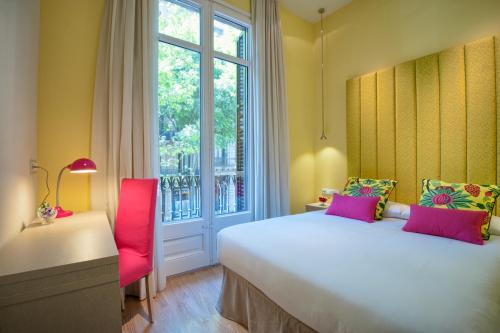 a bedroom with a large bed and a window at BacHome Terrace B&B in Barcelona