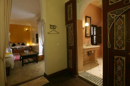 a room with a bathroom and a living room at Dar Sohane in Marrakesh