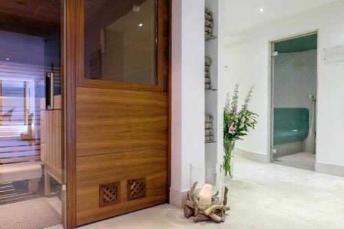 a wooden door in a room with a vase of flowers at Landhaus am Stein in Bad Wiessee