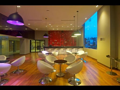 a room with a table and chairs and a kitchen at Keys Select by Lemon Tree Hotels, Visakhapatnam in Visakhapatnam