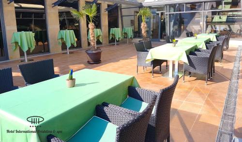 a row of tables and chairs in a restaurant at Hotel International Prishtina & Spa in Pristina