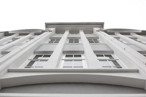 an upward view of a white building with windows at Sand Hotel by Keahotels in Reykjavík