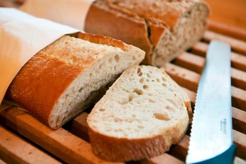 a loaf of bread on a cutting board with a knife at Best Western Rådmannen in Alvesta