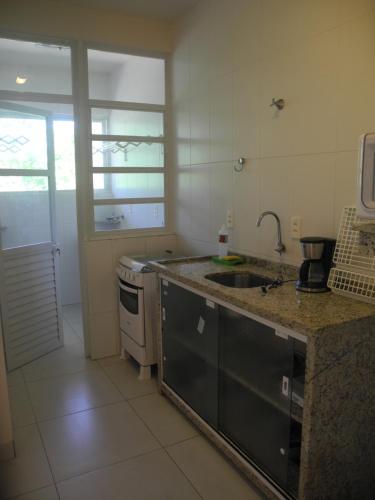 a kitchen with a sink and a counter top at Pousada e Camping Lagoa da Conceição in Florianópolis