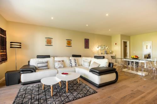 a living room with a couch and a table at Funchal SilverWood Apartment - by LovelyStay in Funchal