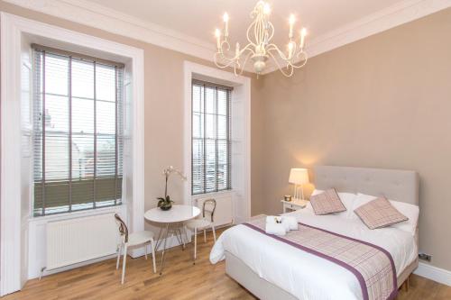 a bedroom with a bed and a table and chairs at Number 1 Park Apartments in Bristol