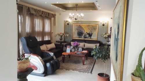 a living room with a couch and a table at Filippos in Nea Moudania