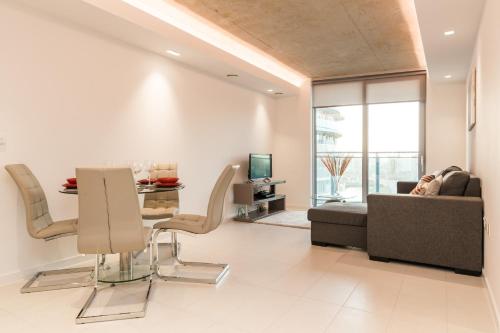 a living room with a couch and a table at Royal Style Apartment - 5 mins walk to ExCeL London in London