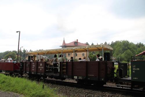 a small train with people riding on it at Hotel BB Bahnhof Bertsdorf in Olbersdorf