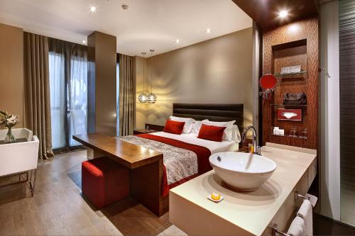 a hotel room with a bed and a sink at Olivia Plaza Hotel in Barcelona