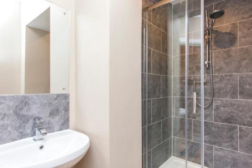 a bathroom with a shower and a toilet and a sink at Number 1 Park Apartments in Bristol