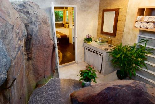 a bathroom with a counter and a sink in a room at Rain Forest Resort in Ban Pak Yang
