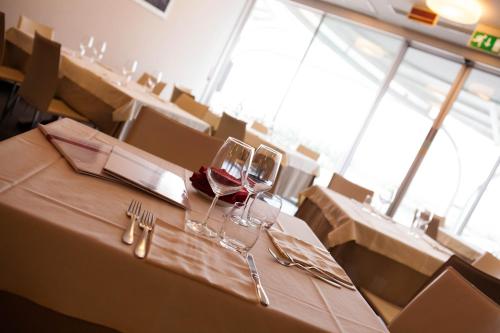 a table with two glasses of red wine on it at Klass Hotel in Castelfidardo
