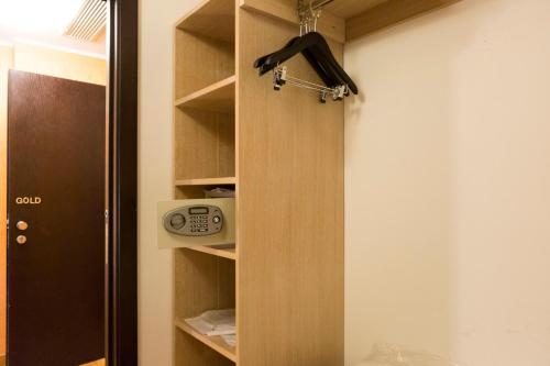 a closet with a door open with a clock in it at Klass Hotel in Castelfidardo