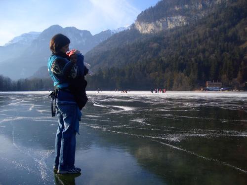 a woman standing on the ice on a lake at Pension Christoph in Kramsach