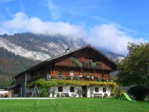 a house with flowers on the side of it at Pension Christoph in Kramsach