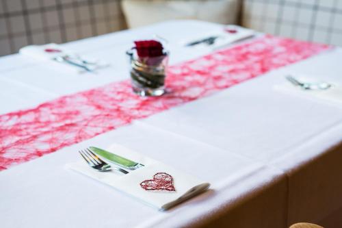 a table with a white table cloth with a knife and fork at Pension Christoph in Kramsach